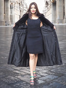 Black long fur coat with shawl collar, open sides, and flared hem