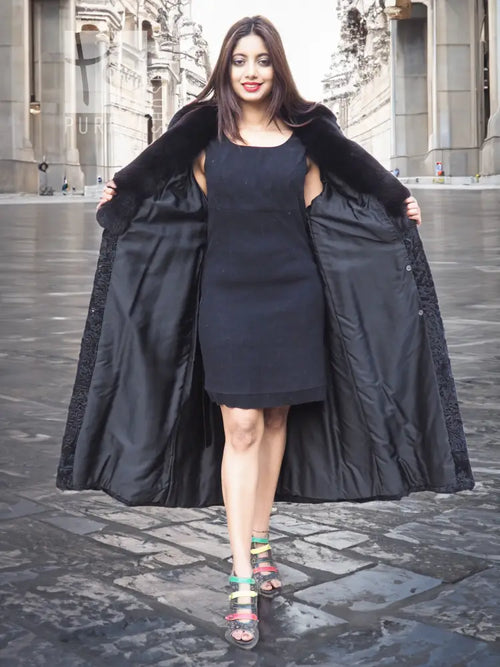 Black long fur coat with shawl collar, open sides, and flared hem