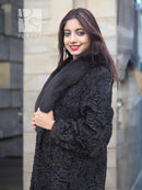 Black long fur coat with shawl collar and textured fabric, three-quarter view