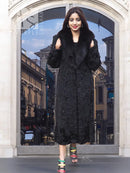Black long fur coat with shawl collar and textured fabric, front view