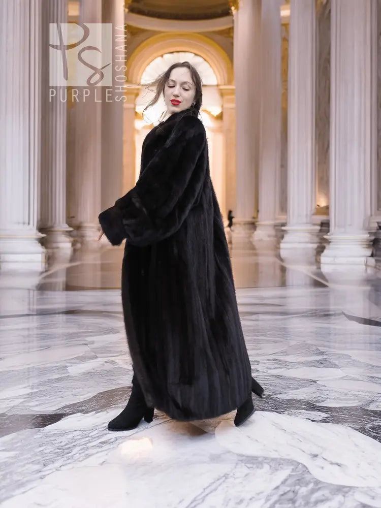 Black mink full-length fur coat with high collar and button front, three-quarter side view