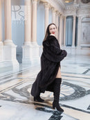 Full-length mink fur coat in dark black, with wide collar and button-front, side view