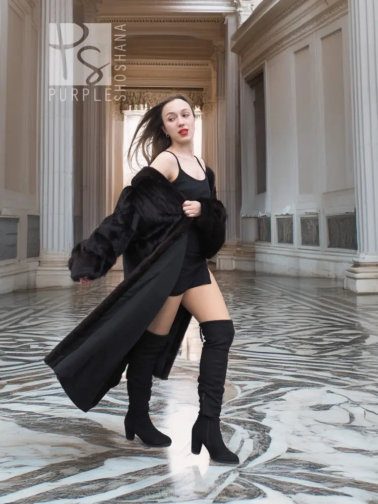Black mink fur coat, full-length with long sleeves and wide, draped shoulders
