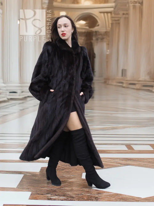 Full-length mink fur coat, dark black, wide collar and button-front, walking stance