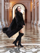 Black mink full-length fur coat with high collar and flowing hem, three-quarter side view