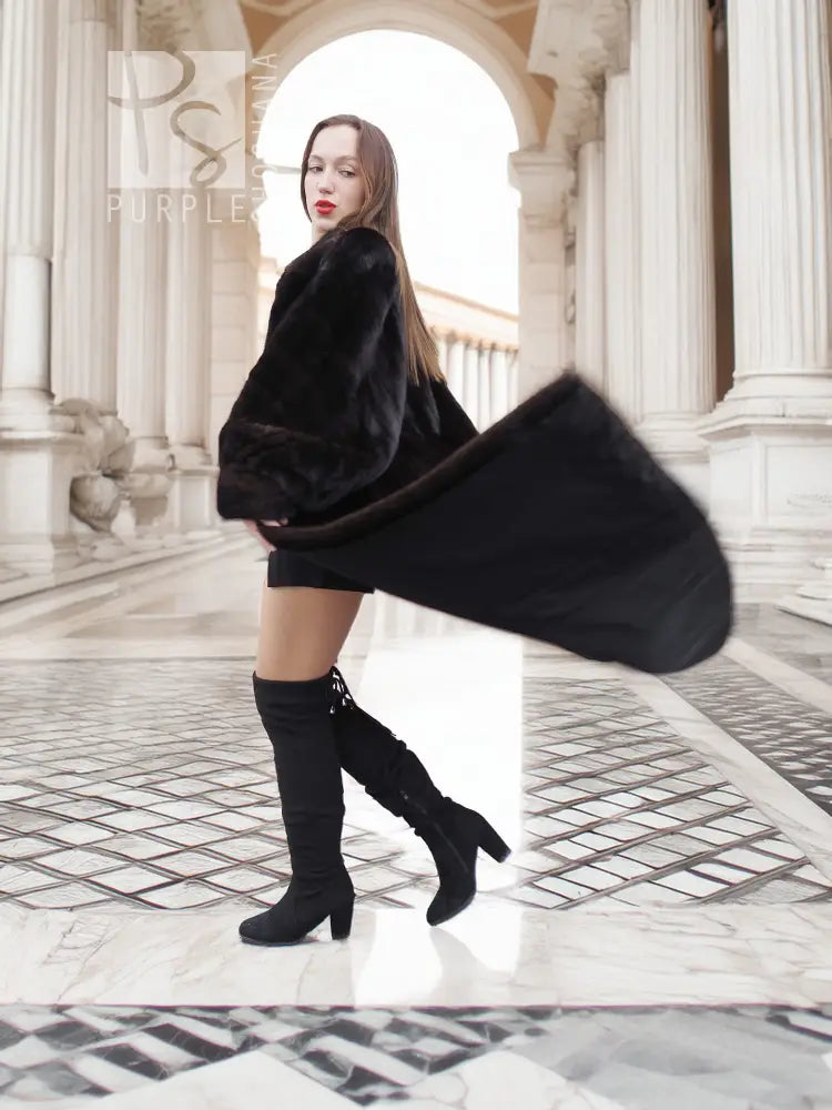 Black mink fur coat, partial side view with plush fur sleeves and full length
