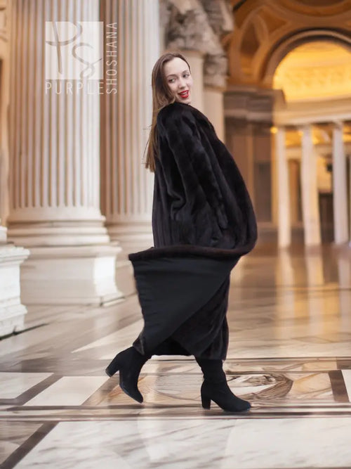 Black mink fur coat, side view with long sleeves and full-length silhouette