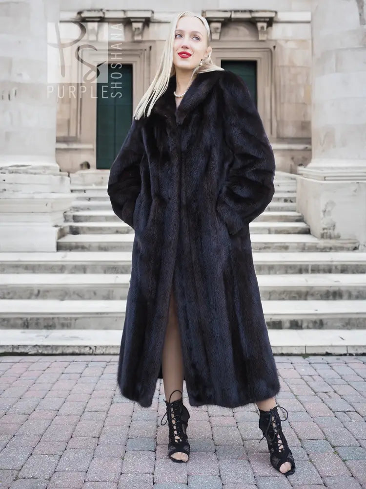 Black mink fur coat with open front and long fur sleeves, midi-to-floor length.