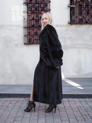 Black mink fur coat with long sleeves and knee-length A-line silhouette