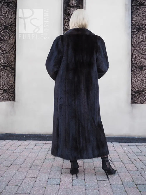 Black mink fur coat, back view with hood and full-length plush fur finish.
