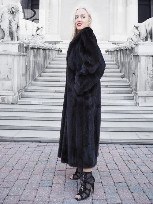Black mink fur coat, long hooded silhouette with soft, dense fur and front closure.