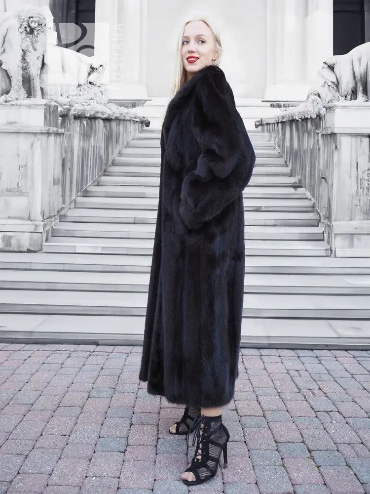 Black mink fur coat, long hooded silhouette with soft, dense fur and front closure.