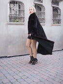 Dark mink fur coat with draped back, wide sleeves, and long hem