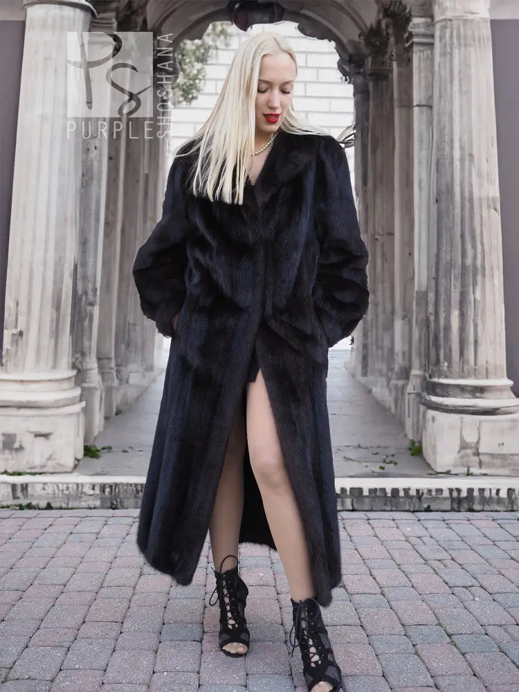 Black mink fur coat with front slit opening, long sleeves, standing straight.