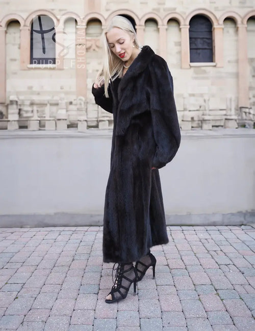 Black mink fur coat, long dark hooded coat with wide sleeves and ankle-length hem.