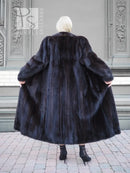 Black mink fur coat back view, rounded shoulders and wide flared hem.