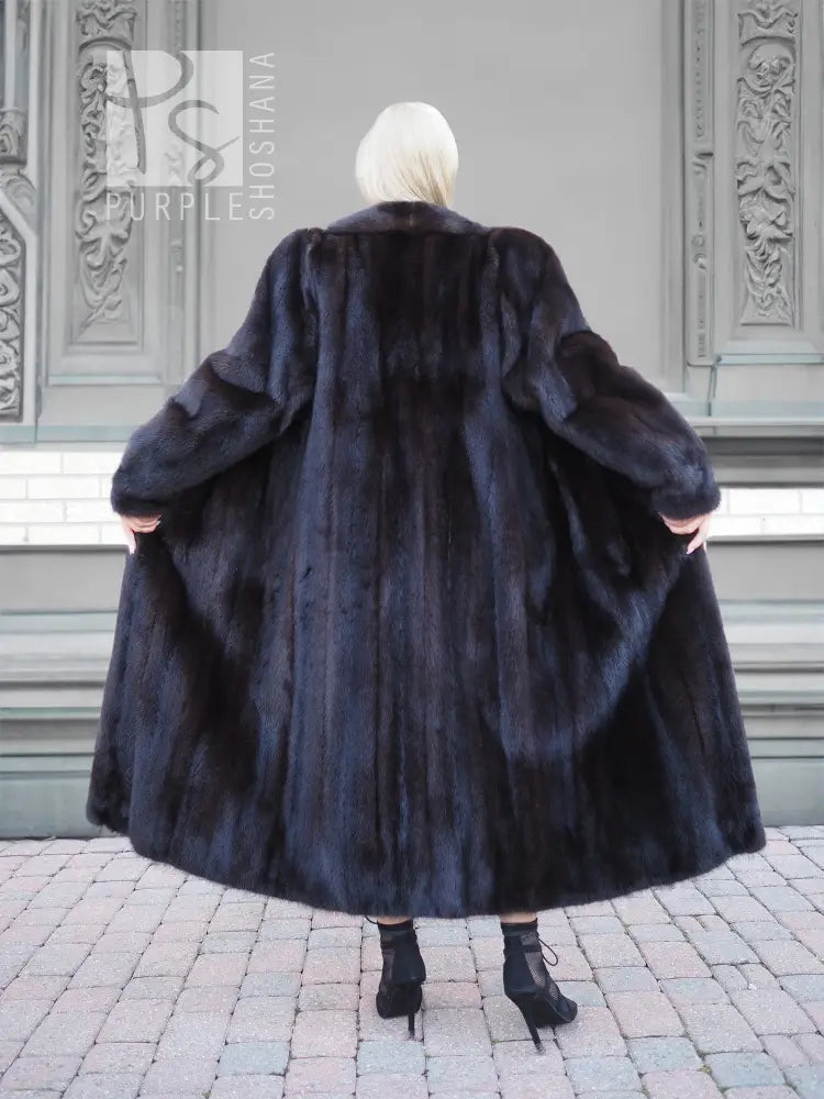 Black mink fur coat back view, rounded shoulders and wide flared hem.