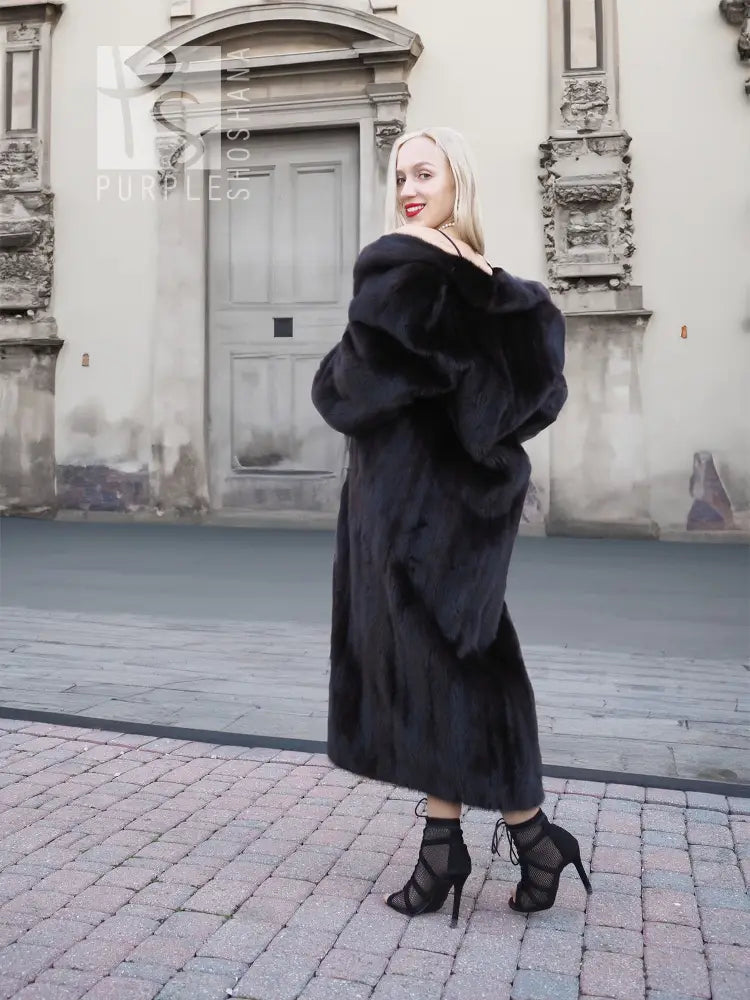 Black mink fur coat, long hooded coat with plush fur cuffs and front closure.