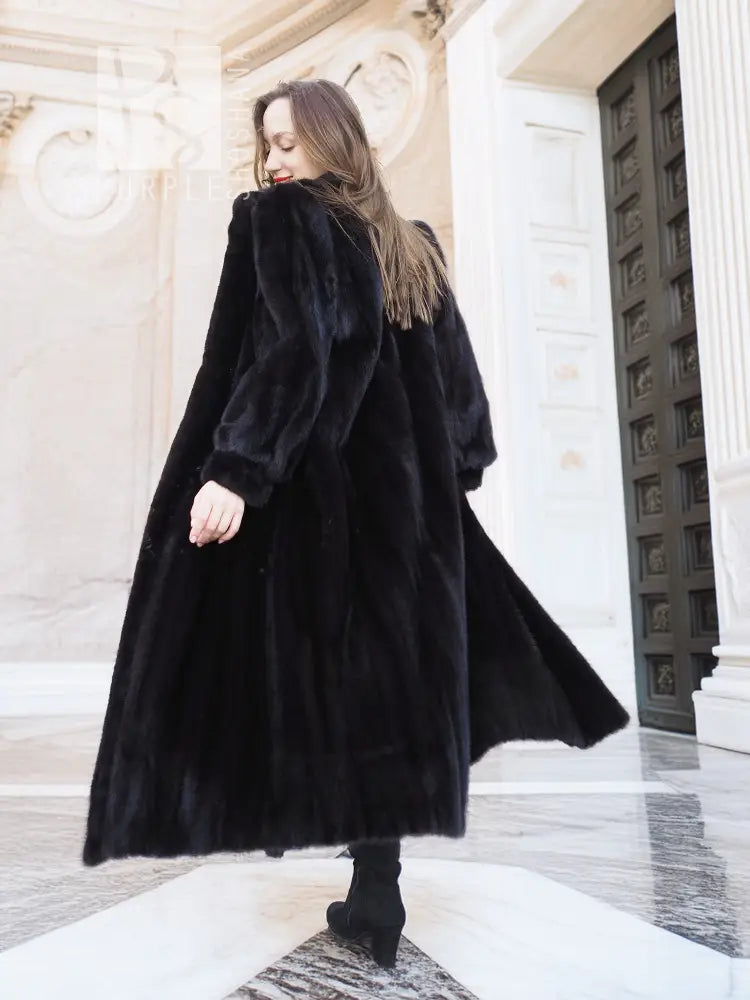Black mink fur coat with flared skirt and long, rounded sleeves
