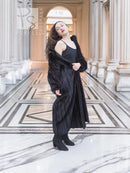 Black mink fur coat, full length with draped shoulders and hand pockets.