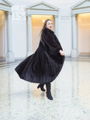 Black mink fur coat, three-quarter view with full skirt flare and tall collar.