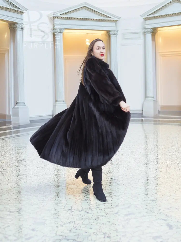 Black mink fur coat, three-quarter view with full skirt flare and tall collar.