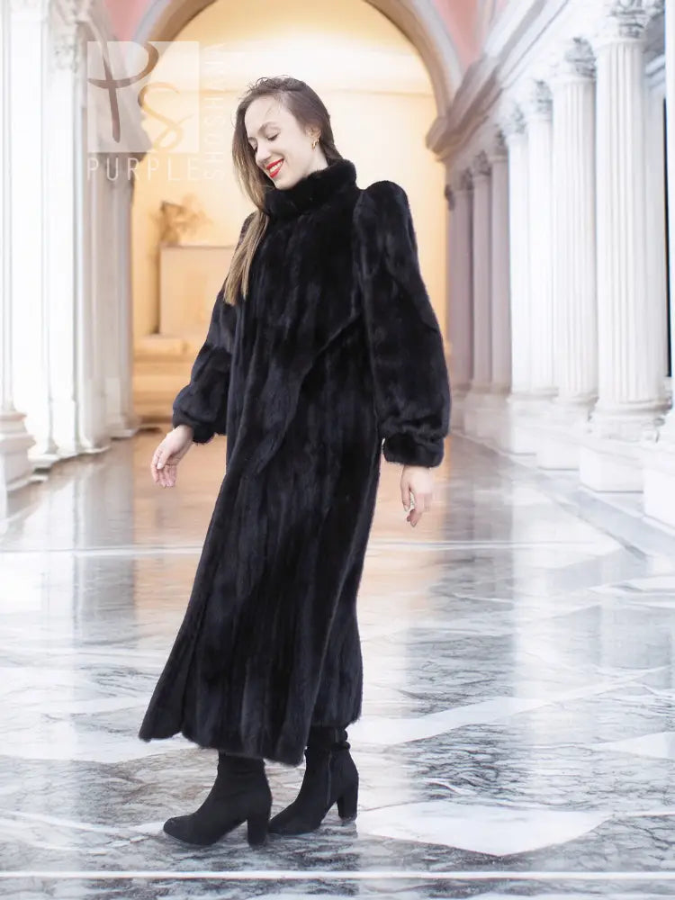 Black mink fur coat in long silhouette with high collar and plush puff sleeves
