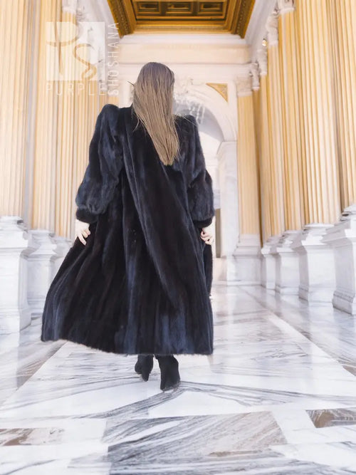Black mink fur coat with long sleeves and full, flared skirt hem