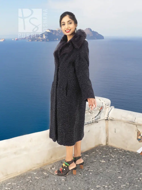 Black curly lamb coat with mink fur collar, side profile, midi length.