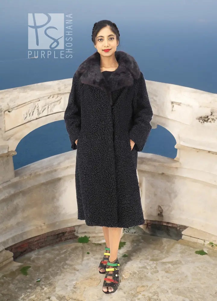 Black curly lamb coat with wide mink collar, knee-length silhouette and long sleeves