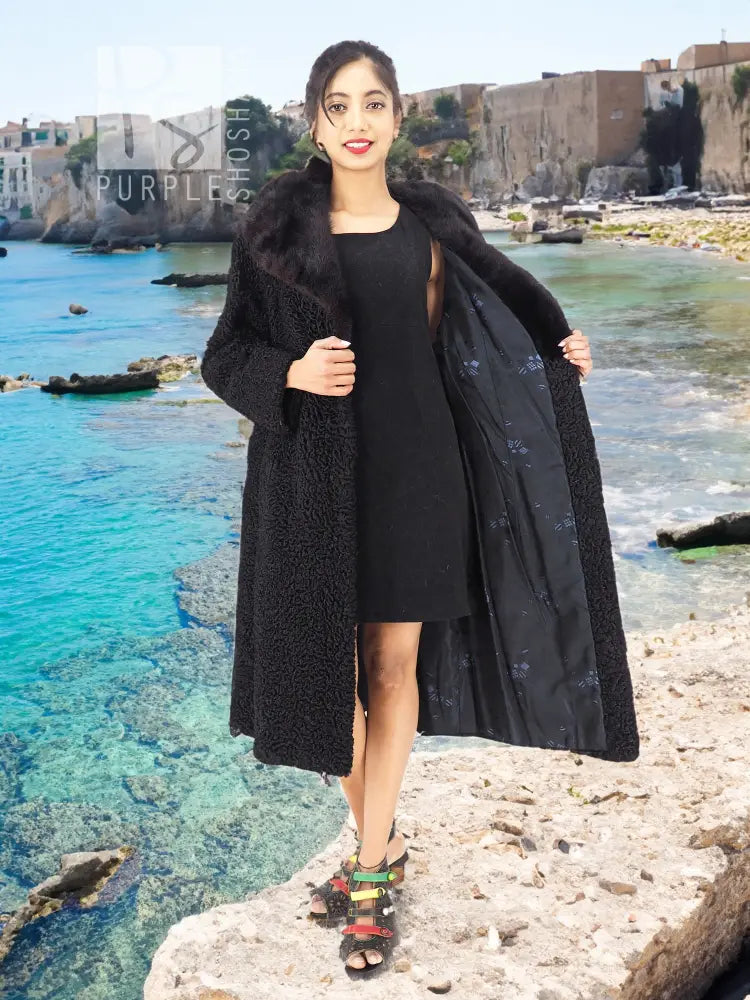 Black curly lamb coat with mink fur collar, open front over dark dress, long sleeves