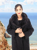 Black curly lamb coat with mink fur collar and front placket, hands near closure