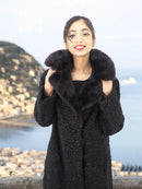 Black curly lamb coat with mink fur collar, close-up of textured front and shoulders
