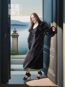 Black mink coat with sculpted collar, long sleeves and dramatic hem sweep, side pose
