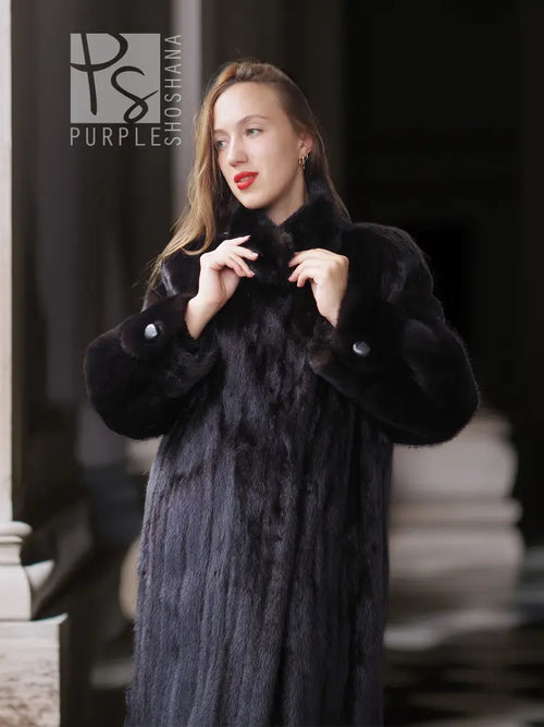Black mink coat with sculpted collar and buttoned cuffs, close-up front