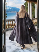 Black mink coat with sculpted collar and dramatic flared sweep back