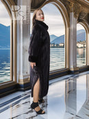 Black mink coat with sculpted collar, long hem, side profile stance