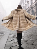 Back view of blonde mink fur stroller jacket with flared cape-style hem, M/L