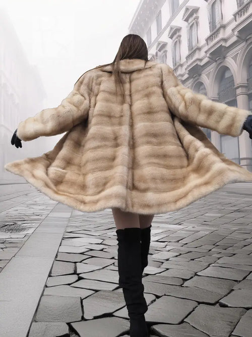 Back view of blonde mink fur stroller jacket with flared cape-style hem, M/L