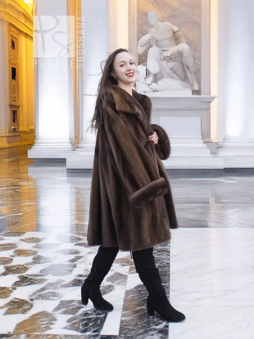 Brown mink fur swing coat with broad collar and long sleeves, above-knee length.