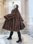 Dark brown mink fur swing coat, flared skirt shape and long sleeves with layered fur.