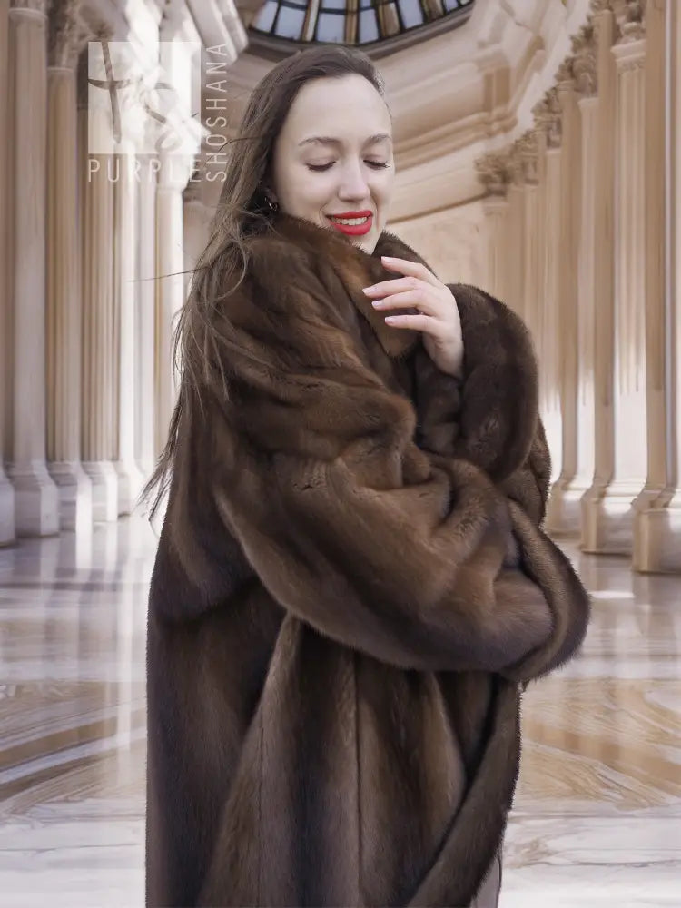 Dark brown mink fur swing coat with wide collar and long sleeves, mid-thigh length.