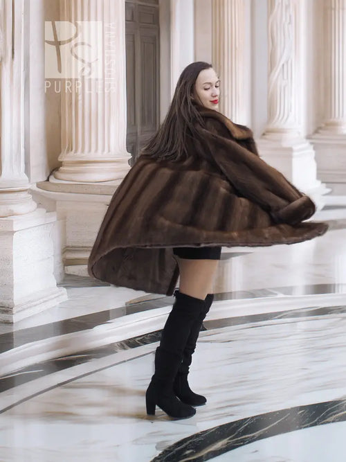 Dark brown fur coat with hood, flared hem, and three-quarter back view.