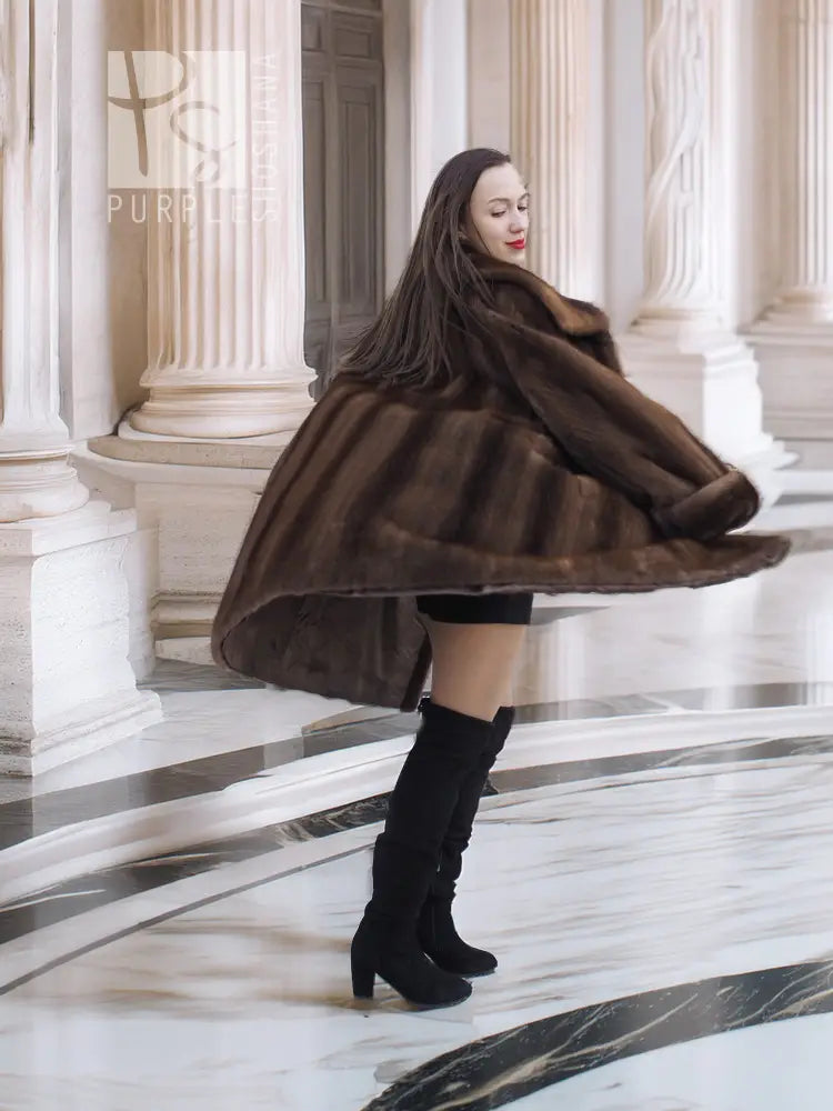 Dark brown fur coat with hood, flared hem, and three-quarter back view.