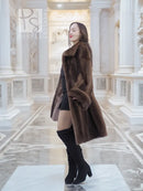 Dark brown fur hooded coat with short hem flare, side view.