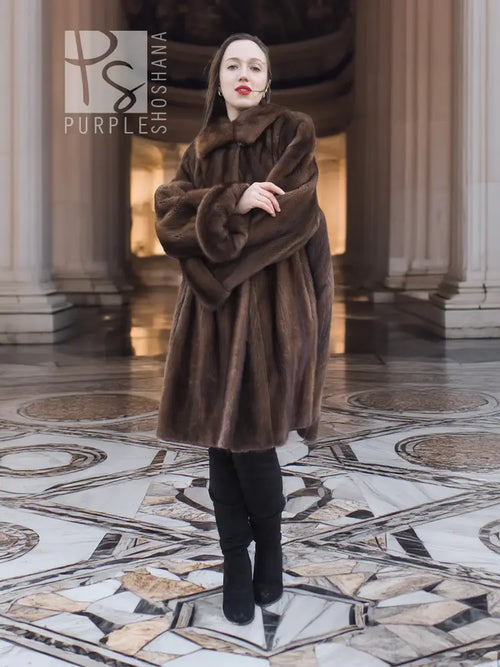 Dark brown fur swing coat with hood and long sleeves, front view.