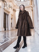 Dark brown fur hooded swing coat with mid-length flare, standing pose.