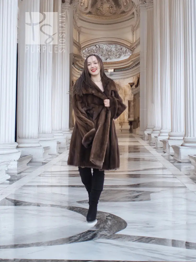 Dark brown mink fur coat with rounded collar and full bell hem, long sleeves.