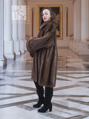 Women’s hooded mink fur swing coat in dark brown, long sleeves, back-turned side view
