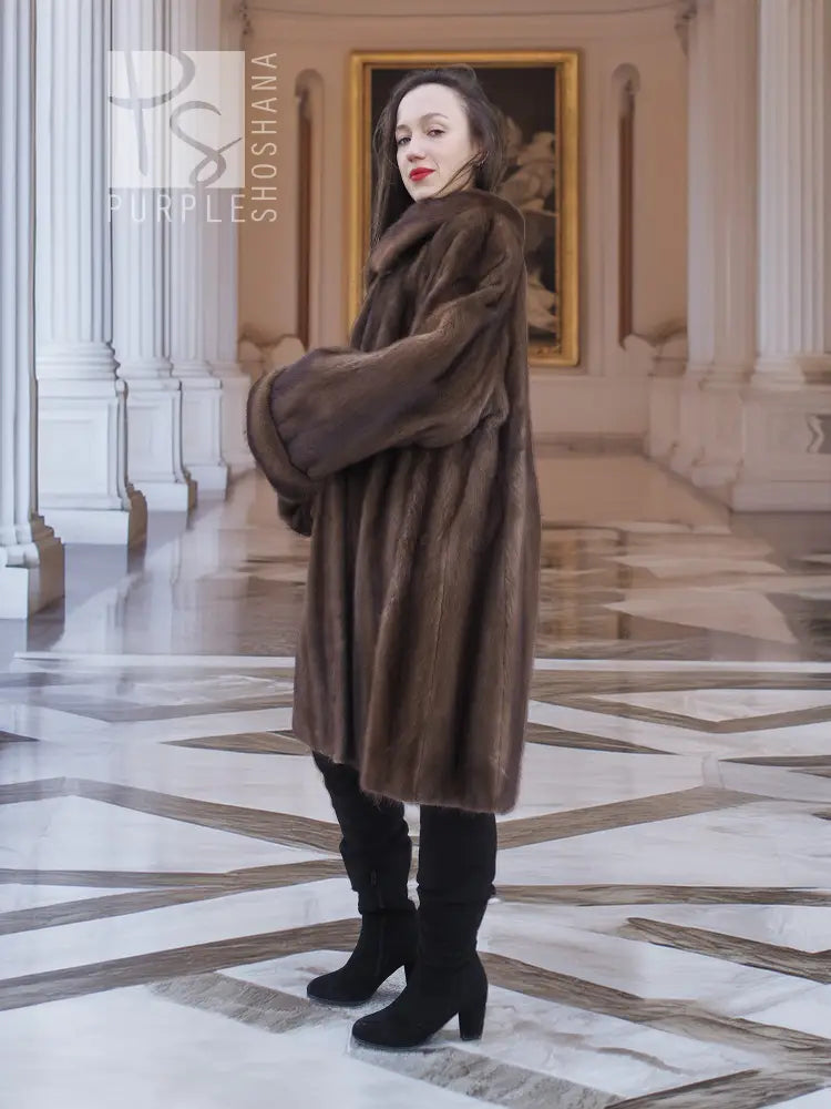 Women’s hooded mink fur swing coat in dark brown, long sleeves, back-turned side view